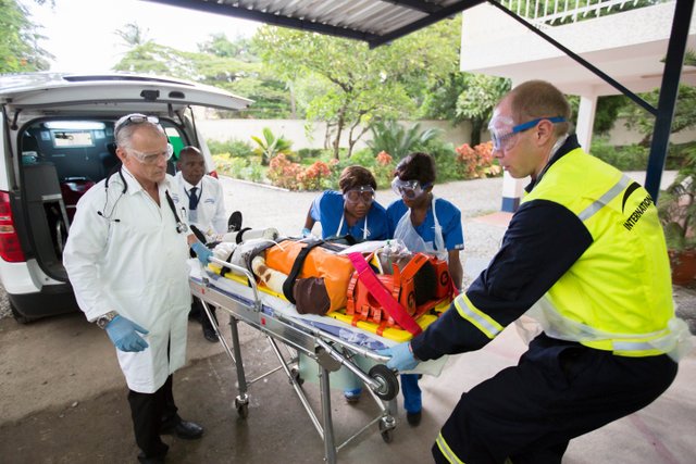 patient on a stretcher being taken into a hospital