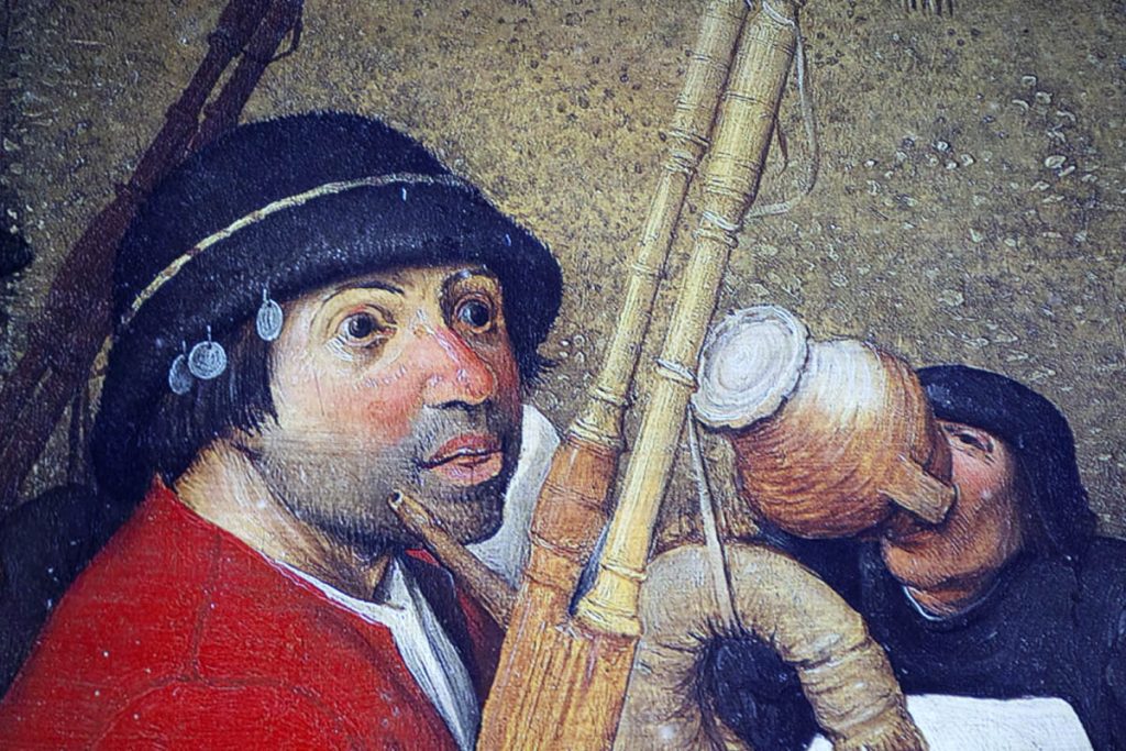 Detail of a male peasant character with bagpipes in a painting by Pieter Bruegel the Elder
