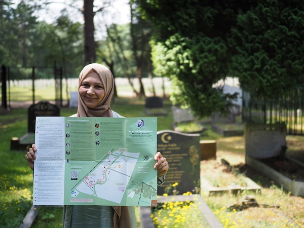 Woman holding map of British Muslim Heritage Trail