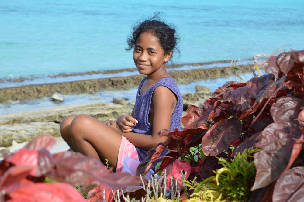 Young person on a beach in Samoa by Petra Shepherd.