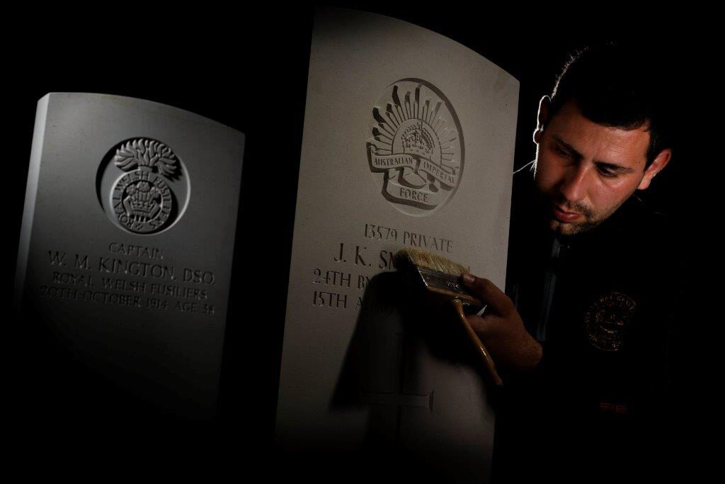 man creating headstone