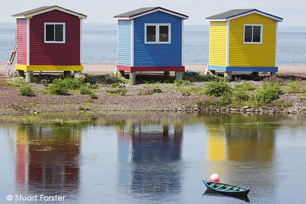 Colourfully painted huts by the shore of the Atlantic Ocean at Heart's Delight-Islington in Newfoundland and Labrador, Canada.