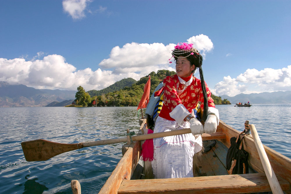 Peter Ellegard photographed a woman rowing on Lugu Lake bordering the Yunnan and Sichuan provinces in China