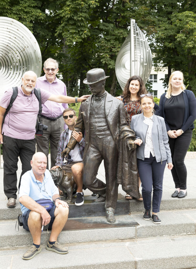 Members of the British Guild of Travel Writers with a statue of Daugavpils' former mayor Pavel Dubrovin