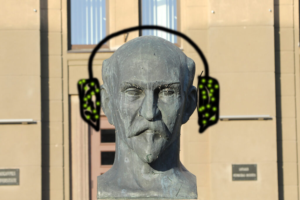 Statue with graffiti headphones.