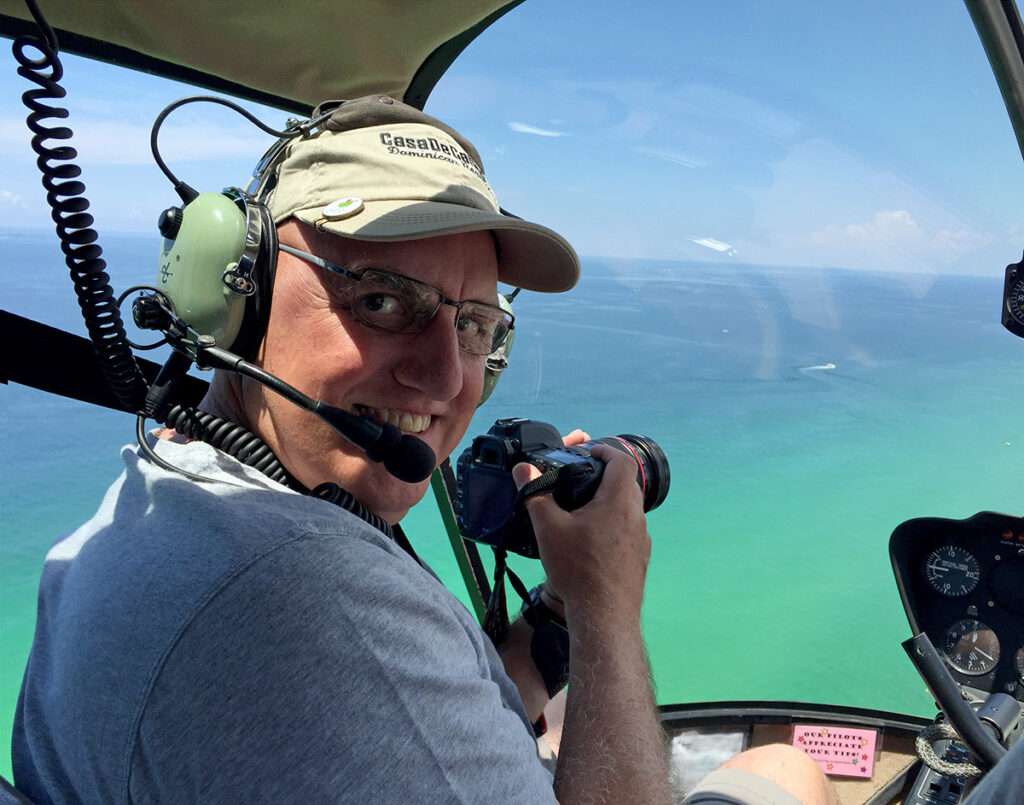 Photographer Peter Ellegard in a helicopter over Panama City Beach Florida