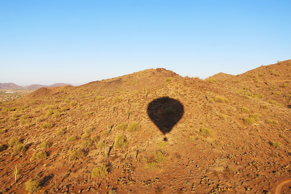 Lynne Coates shadow of a hot air balloon in one of the USA's open spaces.